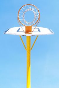 Low angle view of basketball hoop against clear blue sky