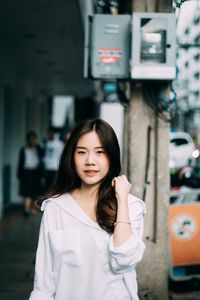 Portrait of beautiful young woman standing outdoors