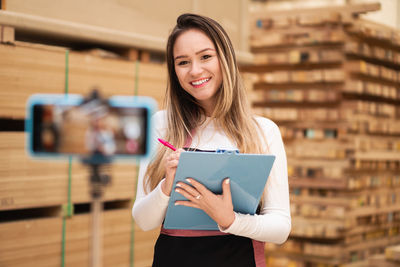 Portrait of young woman holding book