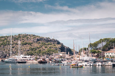 Sailboats moored on sea against sky