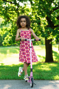 Full length of young woman standing on field