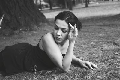 Young woman lying on field