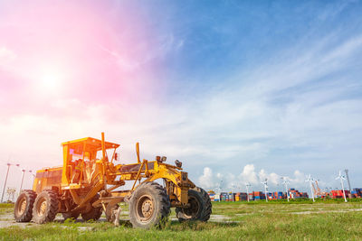 Construction machinery on field against sky