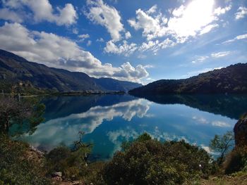 Scenic view of lake and mountains against sky