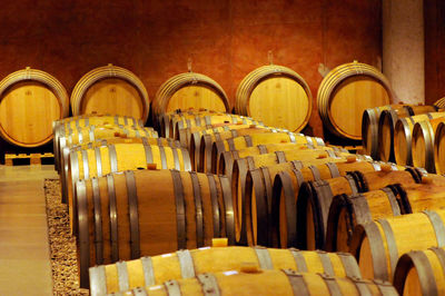 Many wooden barrels in a wine cellar, storage of wine