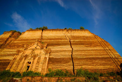 Low angle view of rock formations against sky