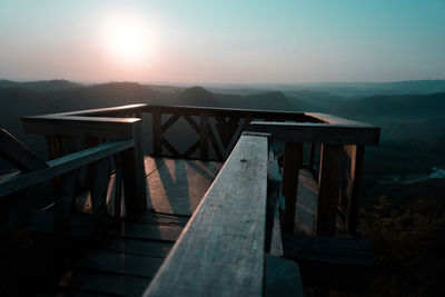 Built structure on railing against sky during sunset