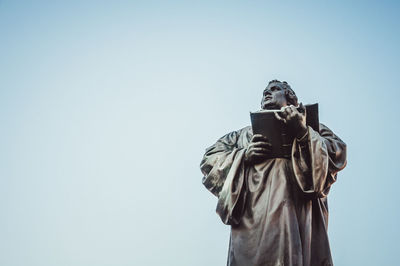 Low angle view of statue against sky