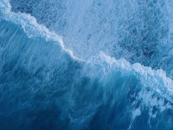 Aerial view of waves splashing in sea