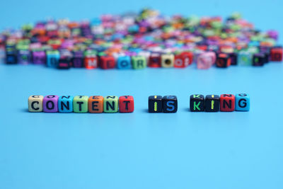 Close-up of toys on table against blue background