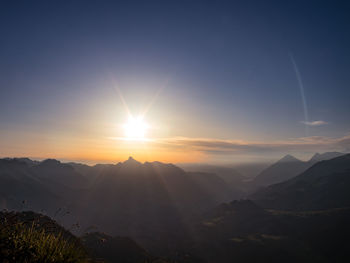 Scenic view of mountains against sky during sunset