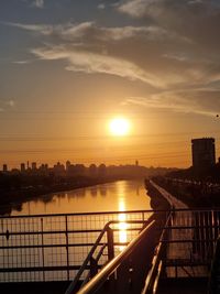 Scenic view of river against sky during sunset