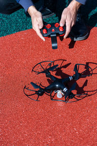 Cropped image of man flying drone outdoors