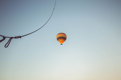 Low angle view of hot air balloons against clear sky