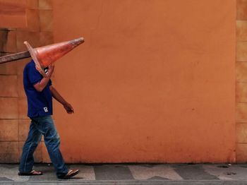Man passing on wall