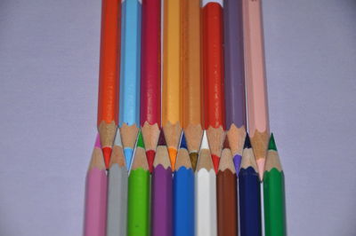 Close-up of colored pencils against white background