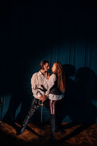 Young couple sitting in the dark