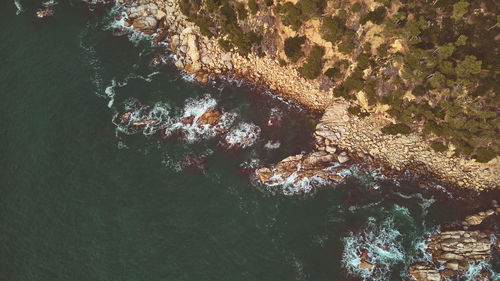 High angle view of rocks by sea