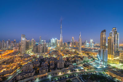 Aerial view of illuminated buildings in city