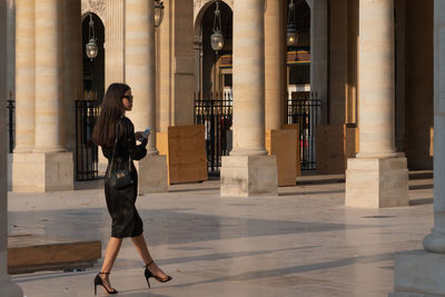 Full length side view of woman walking in building