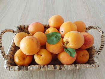 Close-up of fruits, apricots in basket, from above