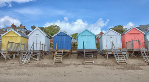 Houses on beach against blue sky