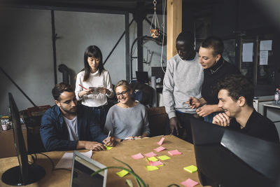 Colleagues discussing over start-up strategy at workplace