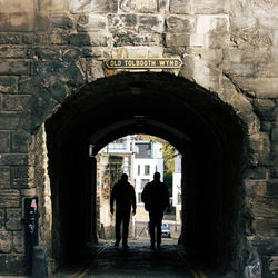 Full length of woman walking in tunnel