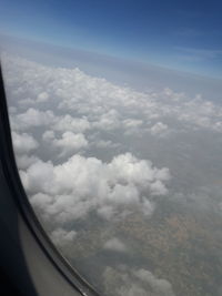 Aerial view of clouds seen from airplane window