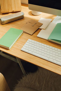 High angle view of books by keyboard on table