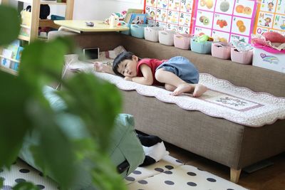 High angle view of woman sleeping on bed at home