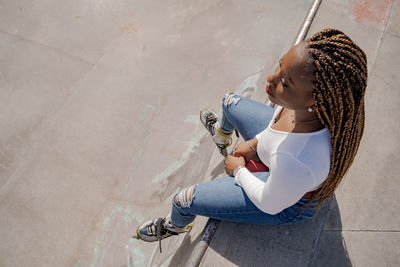 High angle view of woman sitting with shadow