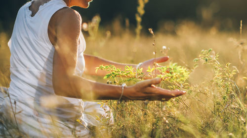 Communion with nature. peaceful woman enjoying the tactile experience of touching plants