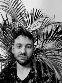 Portrait of young man against plants