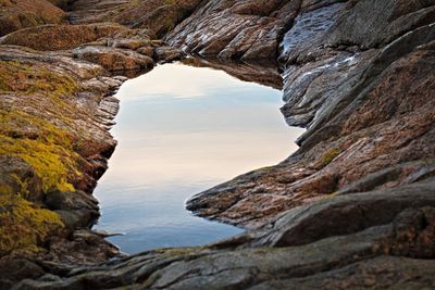 Scenic view of sea and rock formation against sky