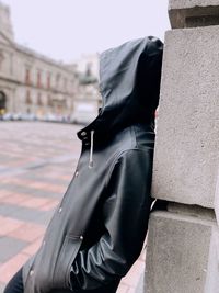 Side view of man standing against wall