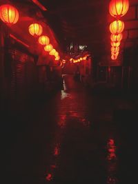 Illuminated lanterns hanging on street at night