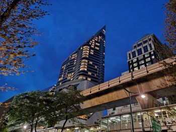 Low angle view of modern building against blue sky