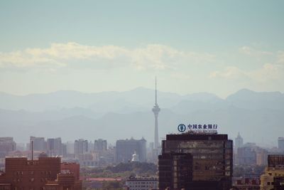 Cityscape against cloudy sky