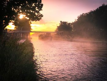 Scenic view of lake against sky during sunset
