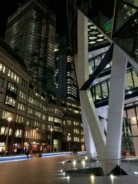 Illuminated modern buildings in city at night