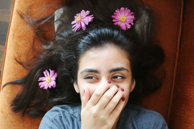 High angle view of woman with hands covering mouth