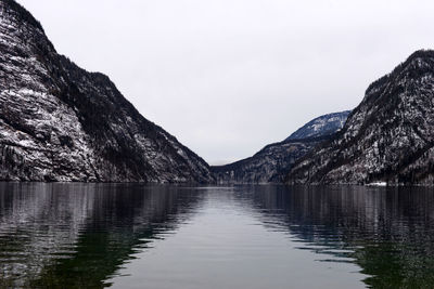 Scenic view of lake and mountains against clear sky