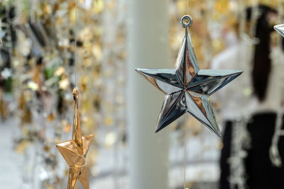 Close-up of christmas decorations hanging on metal