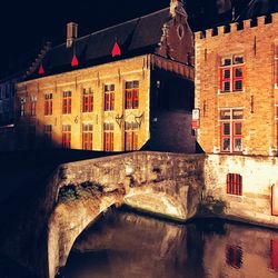 Illuminated building against sky at night