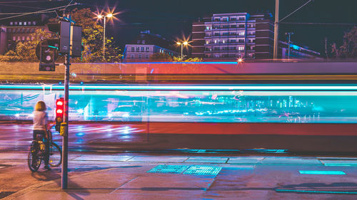 Light trails on road in city at night