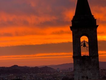 View of tower in city during sunset