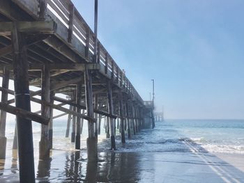 View of long bridge at calm sea