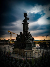 Low angle view of statue against sky at dusk