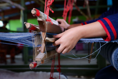 Midsection of woman playing with umbrella